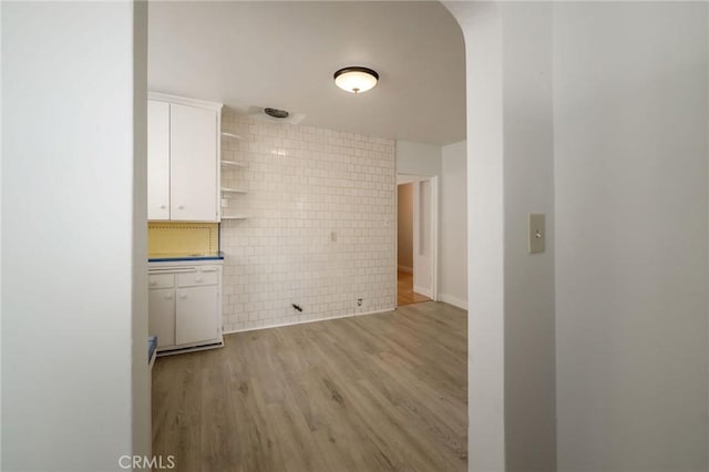 473 W 17th St, San Pedro, CA 90731 - kitchen featuring open shelves, white cabinets, light wood-style flooring, and tile walls