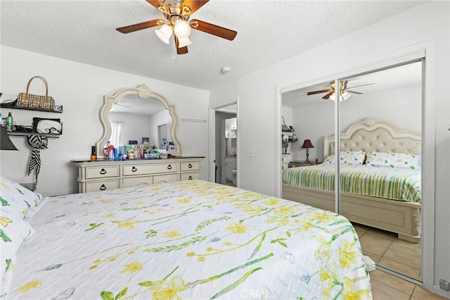 16116 Cajon, Hesperia, CA 92345 - bedroom with light tile patterned floors, a textured ceiling, a ceiling fan, and a closet