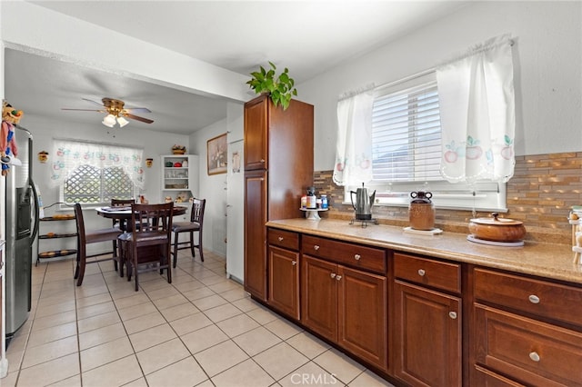 16116 Cajon, Hesperia, CA 92345 - kitchen featuring tasteful backsplash, ceiling fan, light countertops, stainless steel fridge with ice dispenser, and light tile patterned flooring