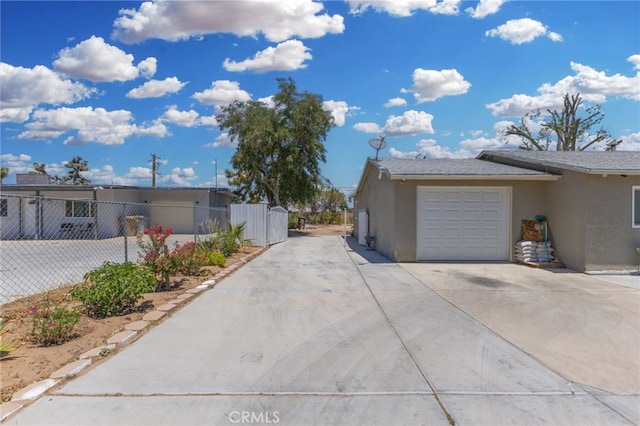 16116 Cajon, Hesperia, CA 92345 - view of side of property featuring stucco siding, concrete driveway, and a garage
