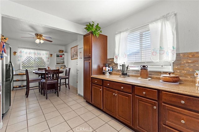 16116 Cajon, Hesperia, CA 92345 - kitchen with tasteful backsplash, ceiling fan, light countertops, stainless steel fridge with ice dispenser, and light tile patterned floors