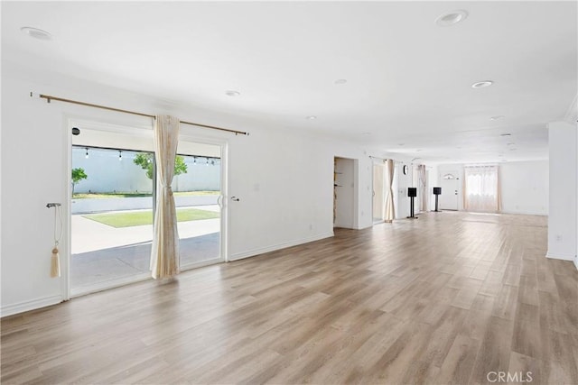 17211 Orozco St, Granada Hills, CA 91344 - unfurnished living room featuring light wood-style floors and baseboards