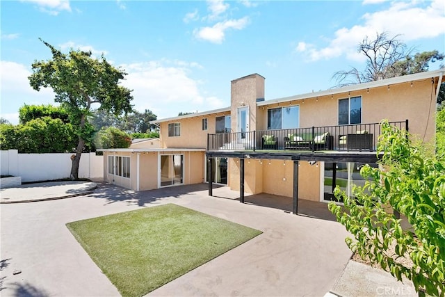 17211 Orozco St, Granada Hills, CA 91344 - back of house featuring a patio, stucco siding, and a balcony