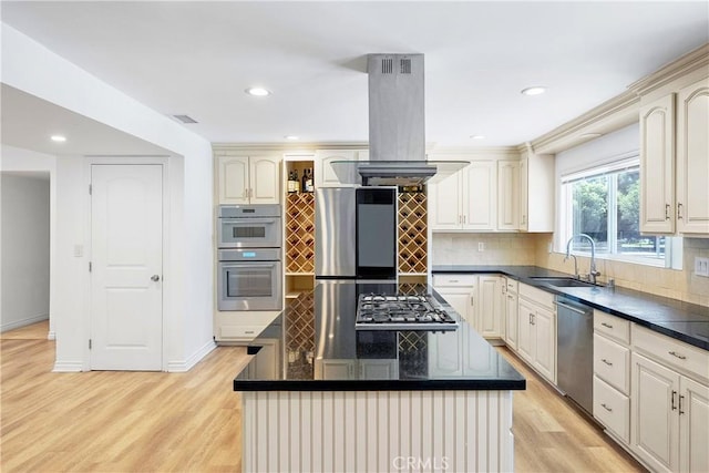 17211 Orozco St, Granada Hills, CA 91344 - kitchen with stainless steel appliances, island range hood, light wood-type flooring, dark countertops, and backsplash