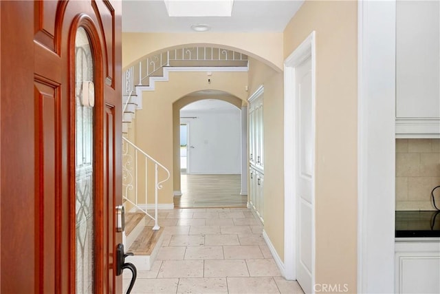 17211 Orozco St, Granada Hills, CA 91344 - foyer entrance with arched walkways, stairway, and light tile patterned floors