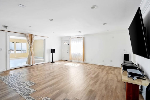 17211 Orozco St, Granada Hills, CA 91344 - unfurnished living room featuring healthy amount of natural light, light wood-type flooring, recessed lighting, and crown molding