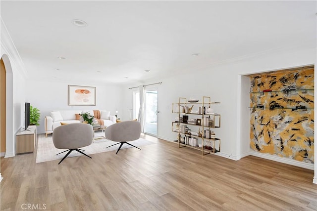 17211 Orozco St, Granada Hills, CA 91344 - living area with arched walkways, ornamental molding, light wood-style floors, and recessed lighting