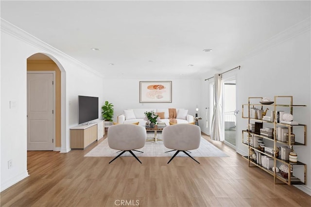 17211 Orozco St, Granada Hills, CA 91344 - living room featuring light wood-style flooring, arched walkways, ornamental molding, and recessed lighting