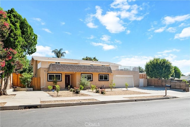 17211 Orozco St, Granada Hills, CA 91344 - view of front facade with stucco siding, concrete driveway, and an attached garage