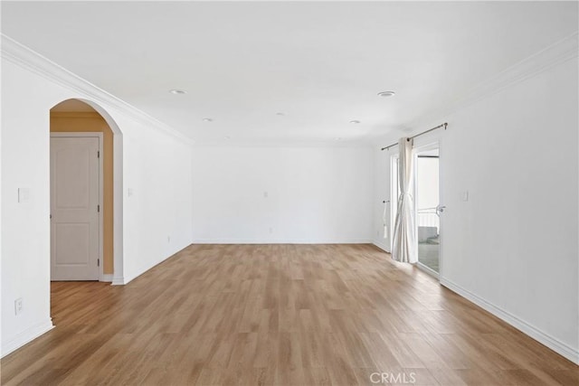 17211 Orozco St, Granada Hills, CA 91344 - empty room with light wood-style floors, arched walkways, and crown molding
