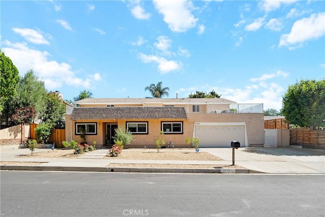 17211 Orozco St, Granada Hills, CA 91344 - view of front facade with driveway, stucco siding, and a garage