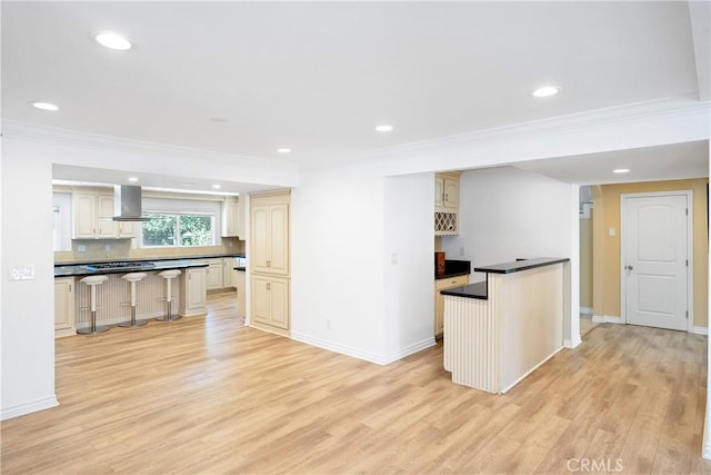 17211 Orozco St, Granada Hills, CA 91344 - kitchen with dark countertops, light wood-style flooring, ornamental molding, extractor fan, and cream cabinets