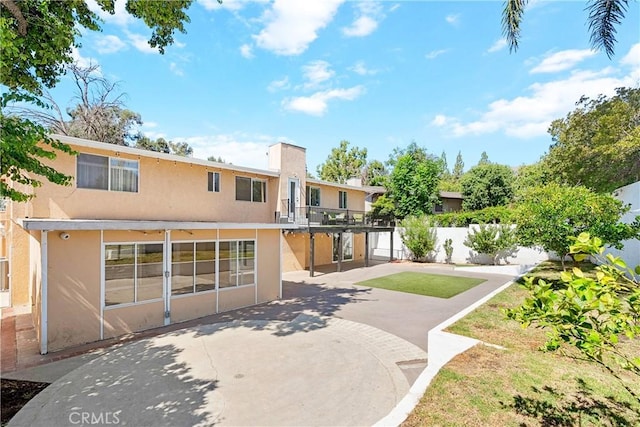 17211 Orozco St, Granada Hills, CA 91344 - back of property with stucco siding and a patio