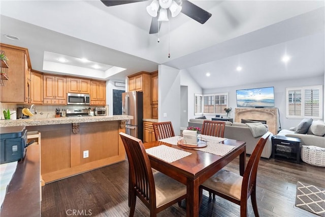 5742 E Hudson Bay Dr, Anaheim, CA 92807 - dining room featuring ceiling fan, dark wood finished floors, a tray ceiling, recessed lighting, and vaulted ceiling
