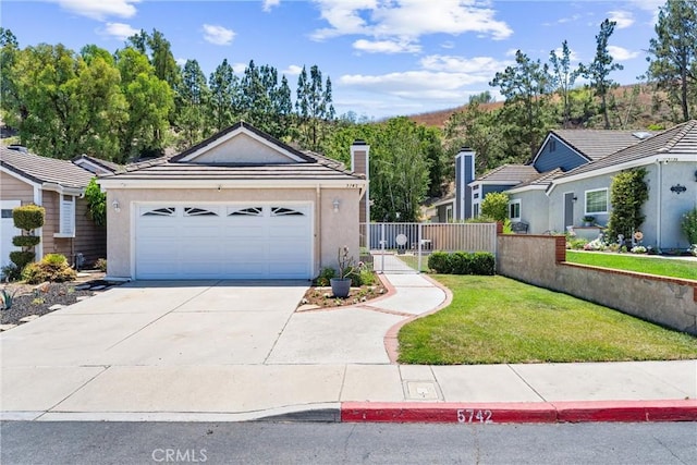 5742 E Hudson Bay Dr, Anaheim, CA 92807 - view of front of house with stucco siding, concrete driveway, a chimney, and a tile roof