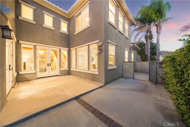 23735 Canyon Vista Ct, Diamond Bar, CA 91765 - back of property at dusk featuring french doors, a patio, and stucco siding