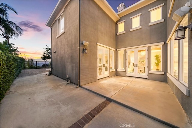23735 Canyon Vista Ct, Diamond Bar, CA 91765 - back of house at dusk with french doors, a patio, and stucco siding