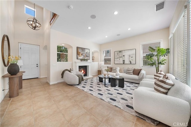 23735 Canyon Vista Ct, Diamond Bar, CA 91765 - tiled living room featuring a chandelier, recessed lighting, and a glass covered fireplace