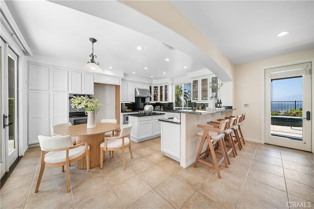 23735 Canyon Vista Ct, Diamond Bar, CA 91765 - kitchen featuring under cabinet range hood, recessed lighting, a peninsula, glass insert cabinets, and white cabinetry