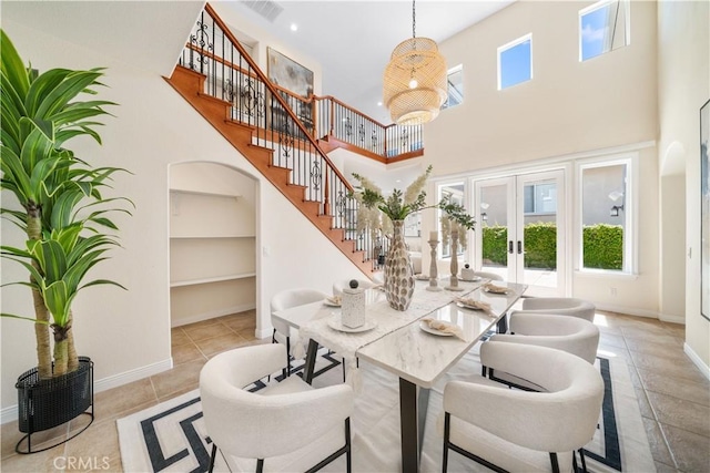 23735 Canyon Vista Ct, Diamond Bar, CA 91765 - dining space with built in features, arched walkways, a towering ceiling, stairway, and french doors