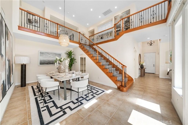 23735 Canyon Vista Ct, Diamond Bar, CA 91765 - tiled dining area with stairs, a towering ceiling, and recessed lighting