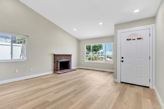 10758 Princess Arlene Dr, Santee, CA 92071 - unfurnished living room with light wood-style floors, a brick fireplace, recessed lighting, and lofted ceiling