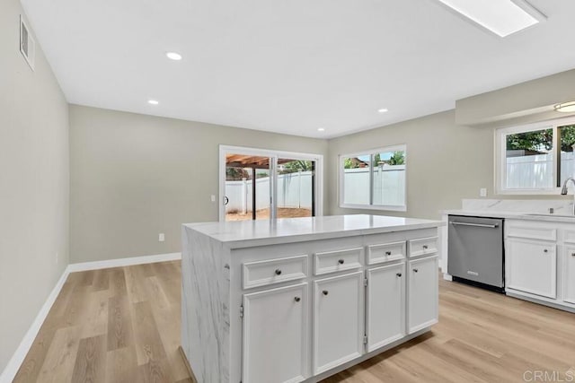10758 Princess Arlene Dr, Santee, CA 92071 - kitchen featuring dishwasher, healthy amount of natural light, white cabinets, light wood finished floors, and recessed lighting