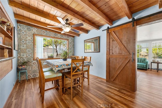 24481 Jutewood Pl, Lake Forest, CA 92630 - dining area with a wooden ceiling with exposed beams, healthy amount of natural light, wood finished floors, a barn door, and a ceiling fan