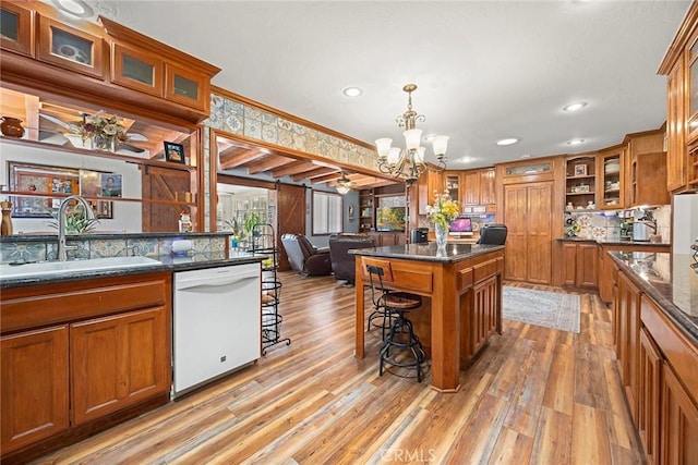 24481 Jutewood Pl, Lake Forest, CA 92630 - kitchen with brown cabinets, white dishwasher, a kitchen bar, recessed lighting, and light wood-style floors