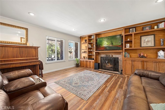 24481 Jutewood Pl, Lake Forest, CA 92630 - living room with a lit fireplace, crown molding, wood finished floors, and recessed lighting