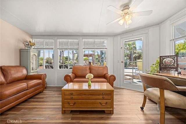 24481 Jutewood Pl, Lake Forest, CA 92630 - living area featuring wood finished floors, a ceiling fan, and a decorative wall