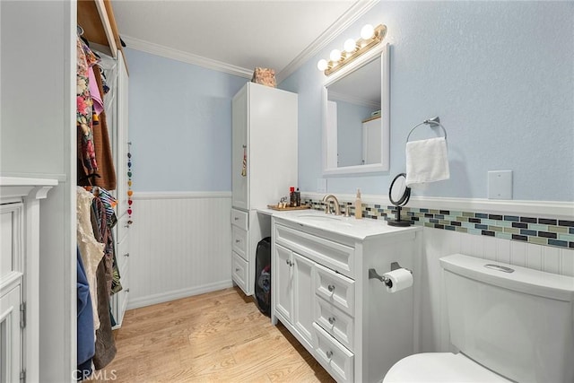 24481 Jutewood Pl, Lake Forest, CA 92630 - bathroom with a wainscoted wall, vanity, ornamental molding, and wood finished floors