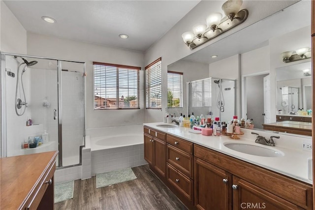 296 Lady Bell Way, Perris, CA 92571 - bathroom with double vanity, a shower stall, a garden tub, and wood finished floors