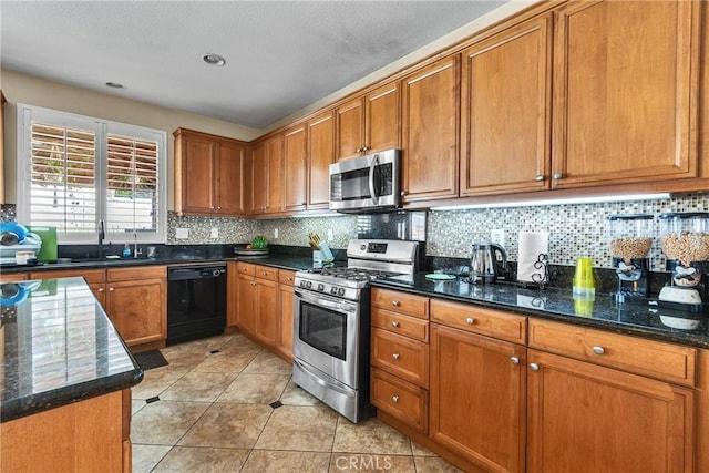 296 Lady Bell Way, Perris, CA 92571 - kitchen featuring stainless steel appliances, brown cabinets, decorative backsplash, and dark stone countertops