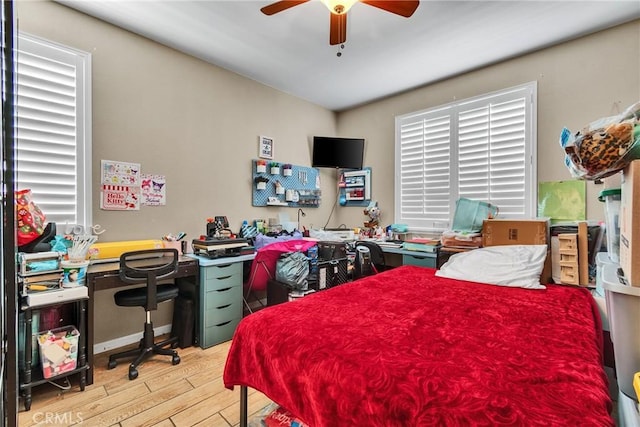 296 Lady Bell Way, Perris, CA 92571 - bedroom with light wood-style flooring, a desk, and a ceiling fan