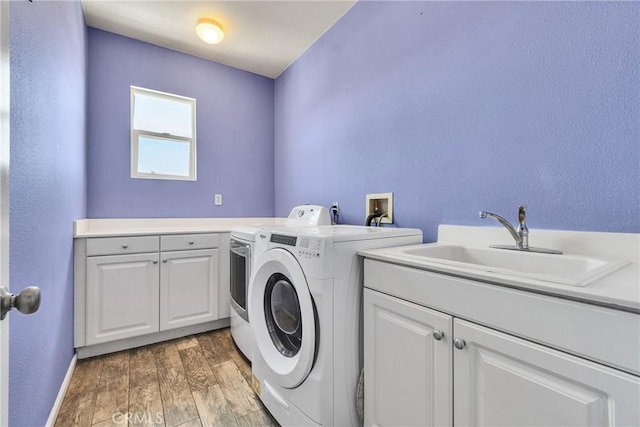 296 Lady Bell Way, Perris, CA 92571 - laundry area with washing machine and clothes dryer, cabinet space, and light wood-style flooring