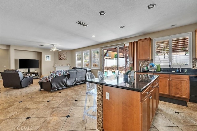 296 Lady Bell Way, Perris, CA 92571 - kitchen with open floor plan, ceiling fan, light tile patterned floors, a kitchen breakfast bar, and a textured ceiling