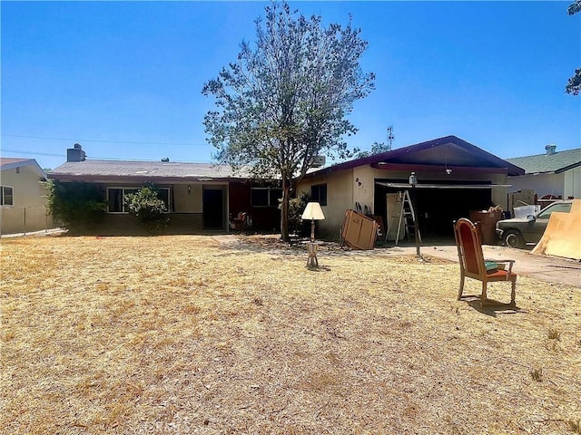 3917 Wood Ln, Bakersfield, CA 93309 - rear view of house featuring a garage and stucco siding