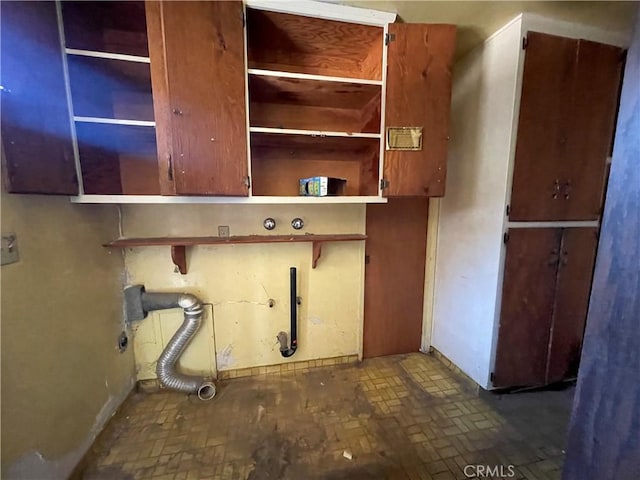 3917 Wood Ln, Bakersfield, CA 93309 - laundry area with brick patterned flooring and cabinet space