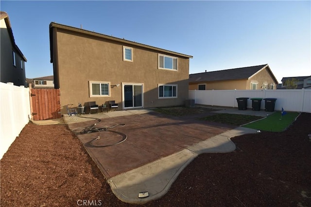 5280 Coyote St, Hemet, CA 92545 - rear view of property with a patio area, stucco siding, a fenced backyard, and an area to practice putting