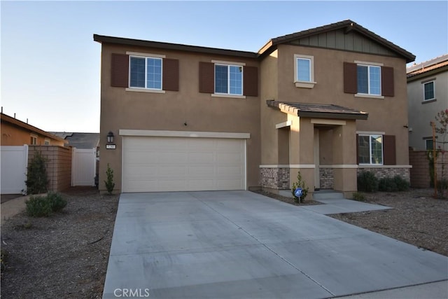 5280 Coyote St, Hemet, CA 92545 - view of front of home featuring stucco siding, an attached garage, concrete driveway, and board and batten siding