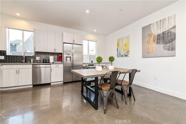 5336 Lemon Grove Ave, Los Angeles, CA 90038 - kitchen featuring appliances with stainless steel finishes, decorative backsplash, dark countertops, and recessed lighting