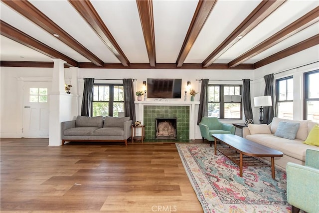 5336 Lemon Grove Ave, Los Angeles, CA 90038 - living area featuring beamed ceiling, a tile fireplace, plenty of natural light, and light wood-style floors
