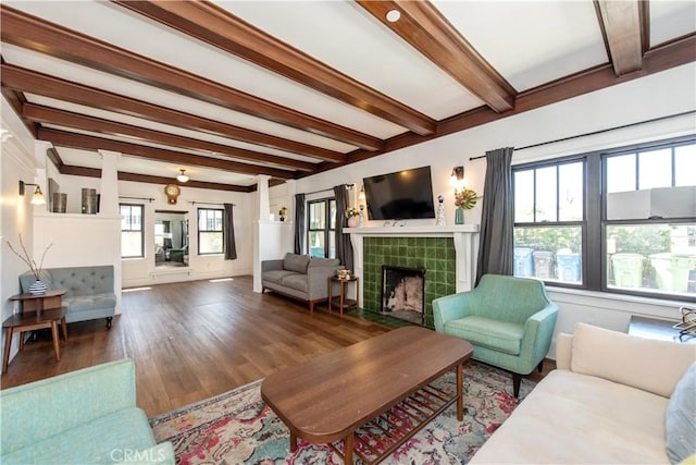 5336 Lemon Grove Ave, Los Angeles, CA 90038 - living area featuring beam ceiling, wood finished floors, and a tiled fireplace