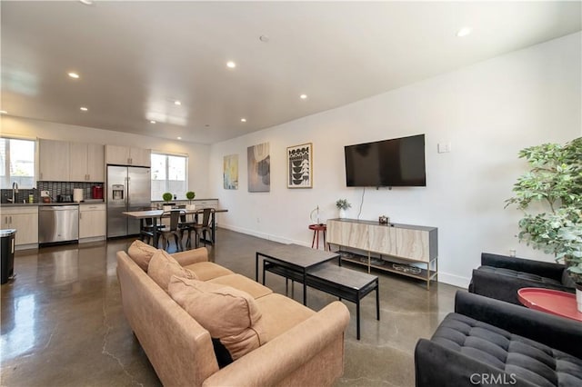 5336 Lemon Grove Ave, Los Angeles, CA 90038 - living room featuring finished concrete floors, plenty of natural light, and recessed lighting