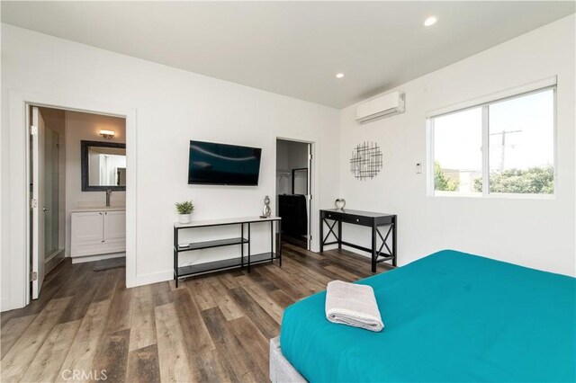 5336 Lemon Grove Ave, Los Angeles, CA 90038 - bedroom featuring wood finished floors, a wall mounted AC, recessed lighting, and ensuite bath