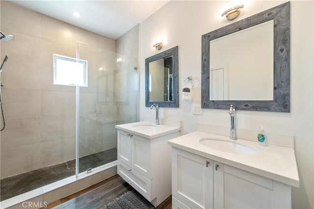 5336 Lemon Grove Ave, Los Angeles, CA 90038 - full bathroom with a stall shower, two vanities, and wood finished floors