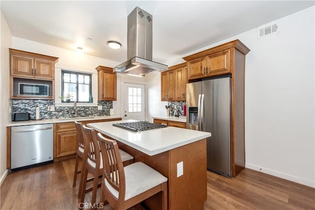 5336 Lemon Grove Ave, Los Angeles, CA 90038 - kitchen with stainless steel appliances, dark wood-type flooring, island exhaust hood, and a center island