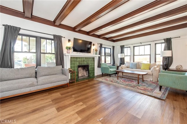 5336 Lemon Grove Ave, Los Angeles, CA 90038 - living room featuring beamed ceiling, a fireplace, and light wood finished floors