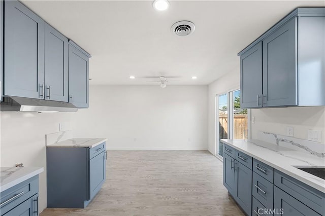 1534 Richfield Ave, Rosamond, CA 93560 - kitchen with a ceiling fan, recessed lighting, light wood-style floors, light stone countertops, and under cabinet range hood